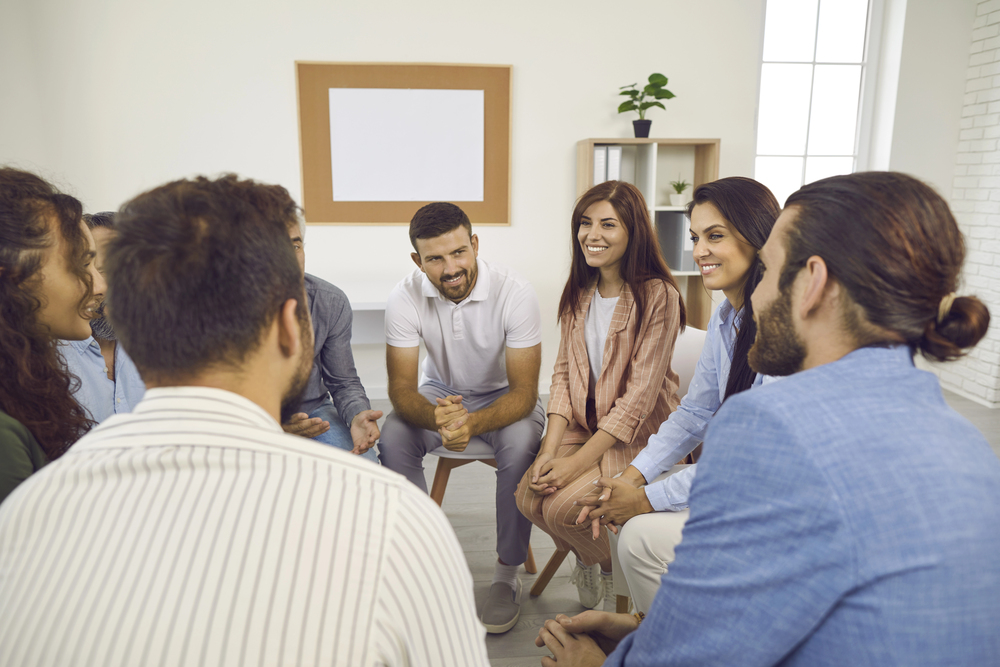 Diverse individuals in a group therapy session